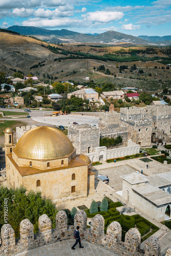 View on the golden dome of Akhmedye mosque, inside the Akhaltsikhe (also called Rabati) castle and the surrounding desert lansdcape in Georgia