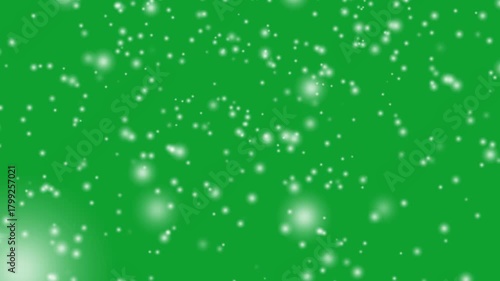 Falling snow on green screen. abstract green background with particles