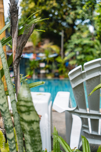 White plastic chair by blue pool