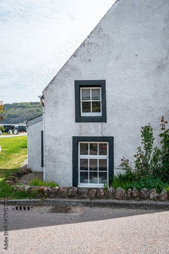 White cottage with dark framed windows