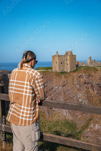 Person views historic Dunnottar Castle from viewpoint