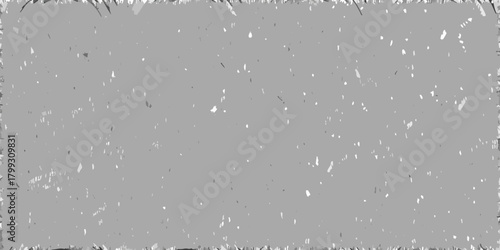 Grungy distressed grey background with white speckles and rough textured edges