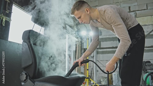 Deep cleaning car seat using steam for a fresh and spotless interior. Steam works its magic, removing dirt and stains from a car seat. Comfort for your vehicle's