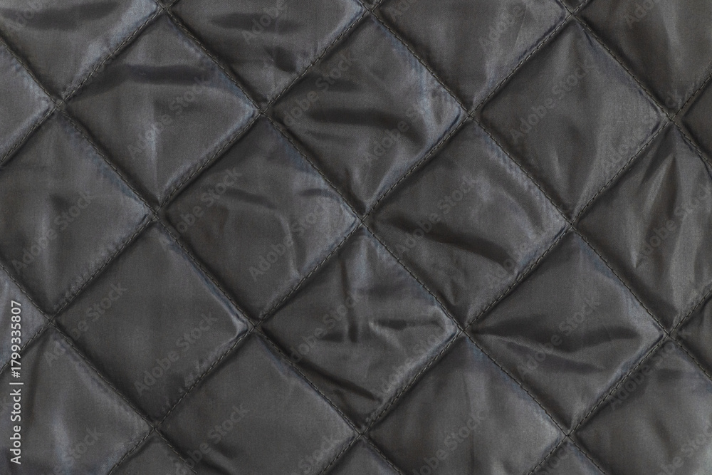 Obraz premium abstract background of dark grey silk quilted fabric texture close up