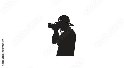 Silhouette of a photographer with a camera and hat, capturing a moment.
