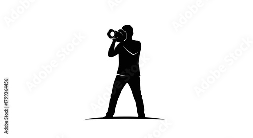 A silhouette of a photographer holding a camera, capturing a moment.