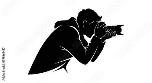 Silhouette of a person holding a camera, capturing a moment, focused on photography.