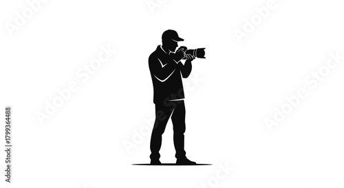 Silhouette of a photographer holding a camera, wearing a cap and jacket, standing in a focused pose.