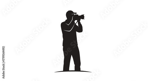 Black silhouette of a photographer standing and holding a professional camera to take a picture on a white background.