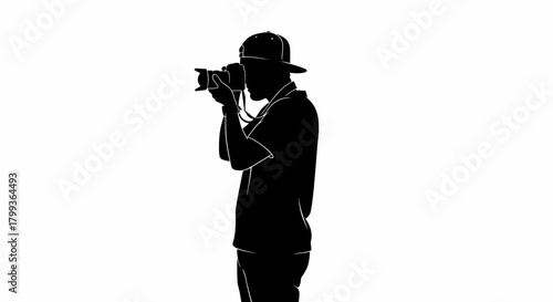 Silhouette of a photographer wearing a cap and holding a camera to take a picture.