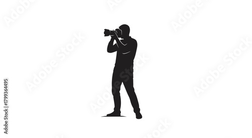 Silhouette of a photographer holding a large camera and taking a picture.