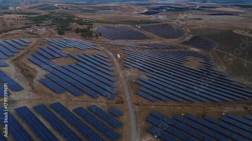 Aerial approaching view of solar panels in a photovoltaic power plant near Paternò in Sicily