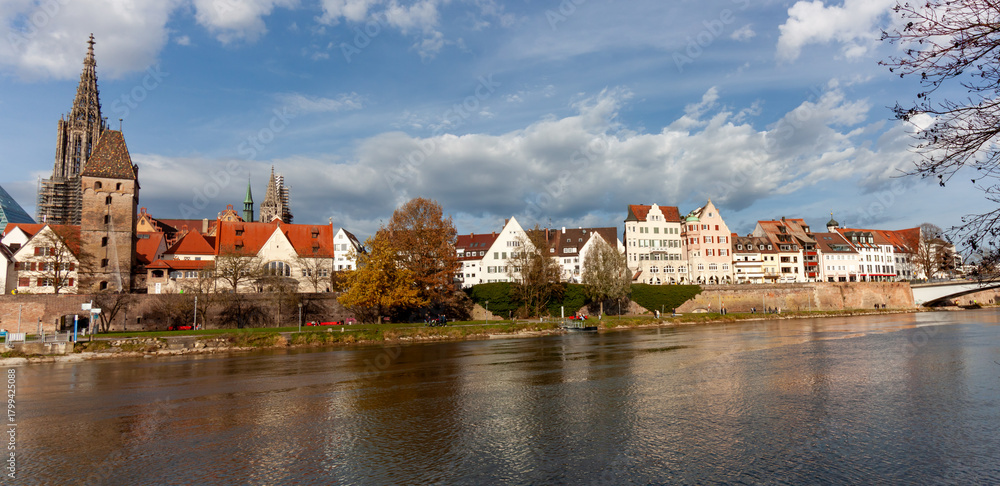 Fototapeta premium Panoramic cityscape of Ulm, featuring the historic Old Town with the famous Ulm Minster cathedral and the Danube River waterfront