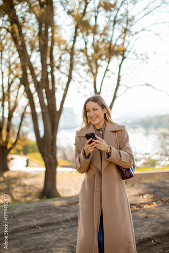 Woman in a stylish coat enj...