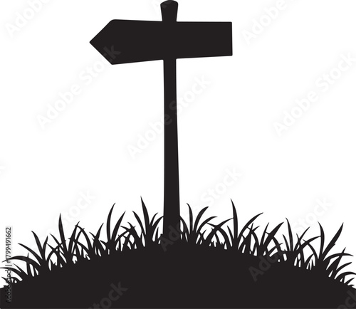 Black silhouette of a directional signpost in grass