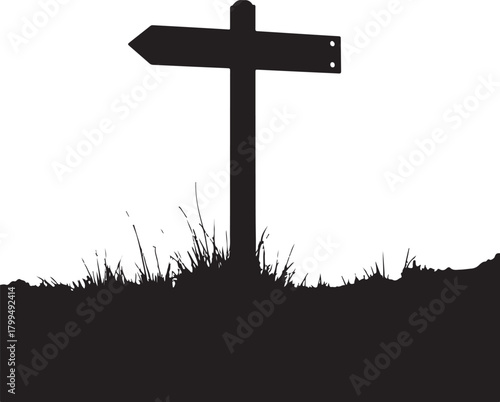 Black silhouette of a directional signpost in grass