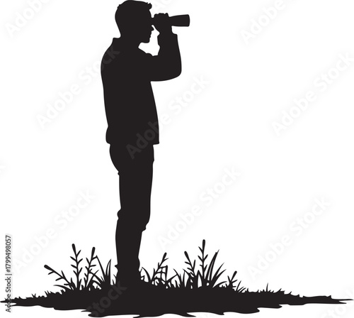 Black silhouette of man looking through binoculars in grass