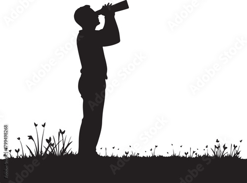 Black silhouette of man looking through telescope in grassy field