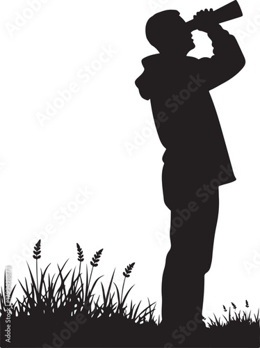 Black silhouette of person in hoodie looking through binoculars over grass