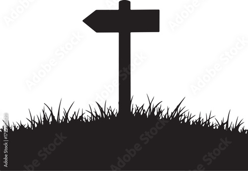 Black silhouette signpost with left arrow in grass