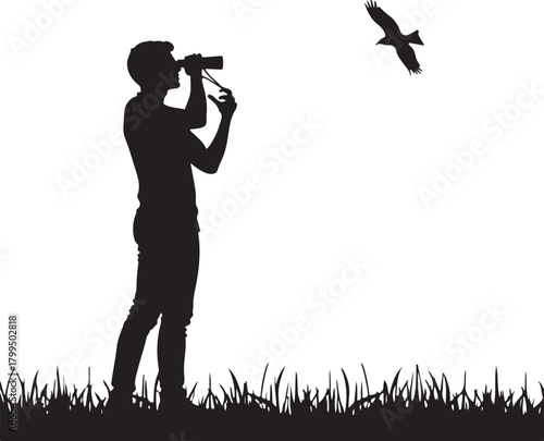 Man silhouette using binoculars observing bird in sky