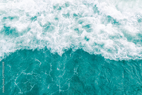 Turquoise olive green ocean wave during summer tide, abstract sea nature background