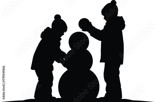 Silhouette of children building a snowman, capturing the joy and fun of winter activities during the holiday season