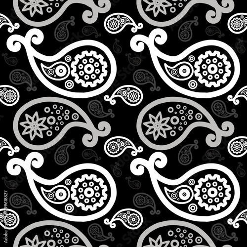 Seamless black and white paisley pattern with ornamental teardrop shapes, floral motifs, and swirls, repeating across a bold background for textile or wallpaper design.