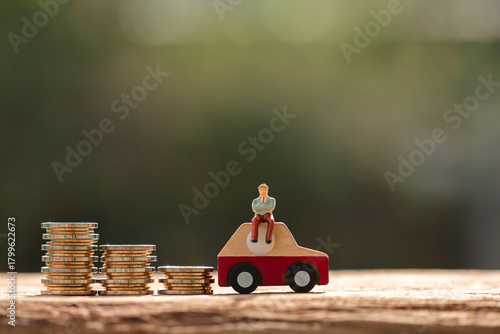 Retired senior old model sit on the car model and the gold coin with growing value of the interest in the public park, Saving money and invest for buy a new chattel or loan in the future concept.