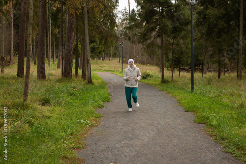 Wallpaper Mural Woman after cancer treatment jogging alone in the park, surrounded by nature and soft light Torontodigital.ca