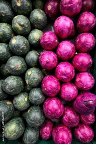 Assortment of Cabbage Varieties in a Grocery Bin A top down view of a modern, clean grocery store bin filled with a colorful assortment of cabbages. Include both vibrant red cabbages and deep green