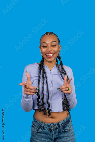 Young woman smiling and gesturing pointing in front