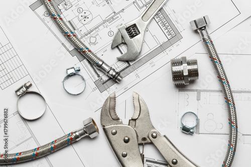 Plumbing tools and materials are on the drawing