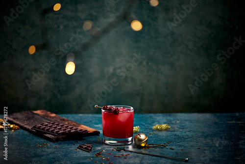 Festive Red Cocktail with Cherries on Rustic Table with Chocolate