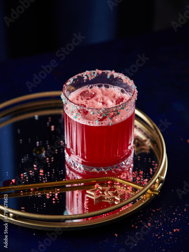 Festive Pink Holiday Cocktail with Candy Rim on Decorative Tray