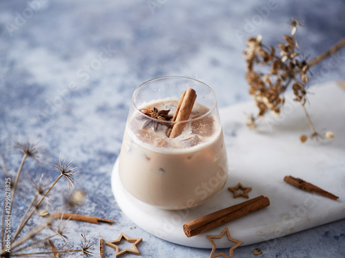 Iced Winter Spiced Cocktail with Cinnamon and Star Anise on Marble Board