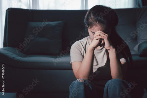 Fototapete Sorrowful woman sat alone, overwhelmed by emotion, her sad and unhappy expression revealing deep despair, stress and distress left feeling depressed