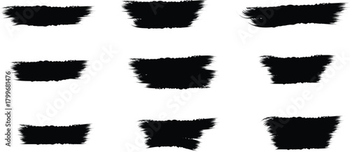 Collection of nine black rough textured brush stroke elements on white background