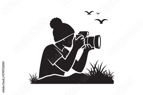 Silhouette of a person photographing birds in nature