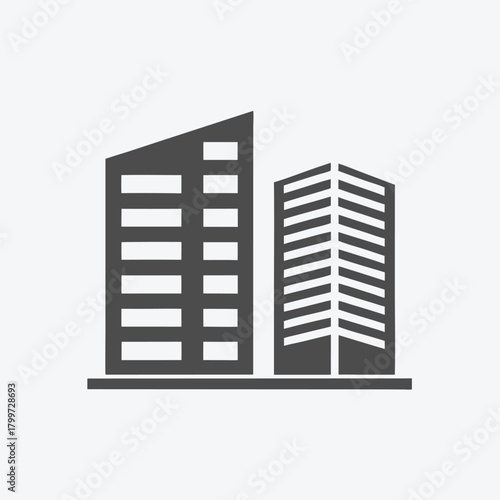 Two geometric gray buildings stand side by side against the clear white background together