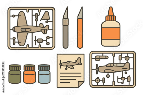 Scale model airplane kit components including sprues, hobby knives, paint, and glue