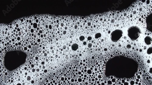 Texture of white soap foam with bubbles abstract background. Soap sud macro structure. Bathtup Soap Foam. Natural White Shampoo Bubbles Motion. High quality 4k footage