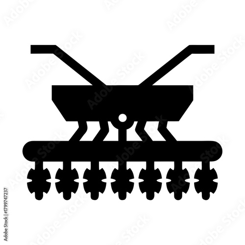 Silhouette of a farm seeder machine with multiple discs