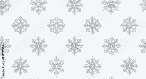 A seamless pattern of delicate gray snowflakes on a light gray background creating a wintery and festive holiday theme.