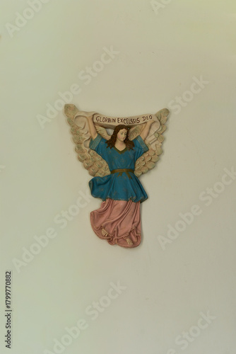 religious decoration, Religious wall carving of an angel holding a banner inscribed 