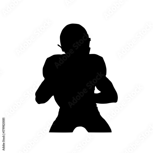 Silhouette of an american football player in uniform ready to throw a pass against a white background