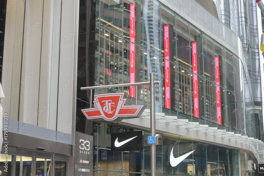 Fototapeta premium exterior of 33 Bloor St E, public transit subway entrance logo sign, and facade of Nike Bloor, Toronto