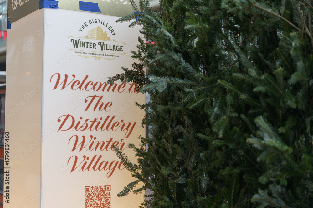 Fototapeta premium Winter Village sign with evergreens at The Distillery Historic District, Toronto