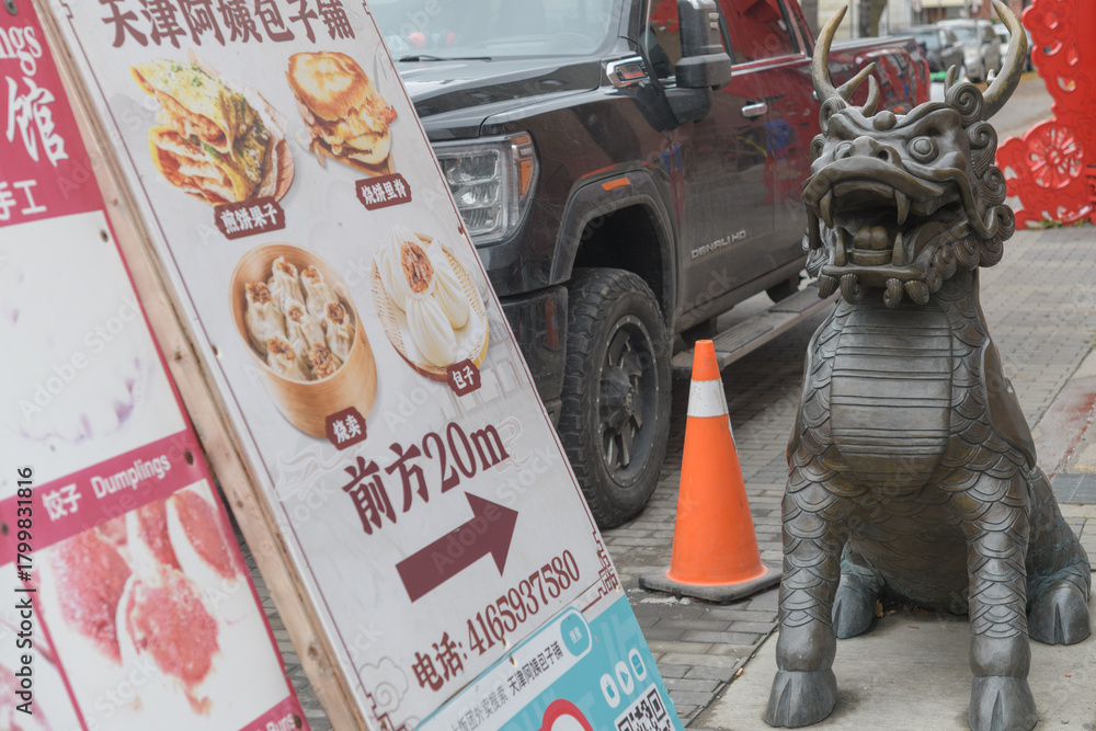 Naklejka premium auspicious bronze cast Qilin sculpture at Huron Square, Chinatown, Dundas St W, Toronto