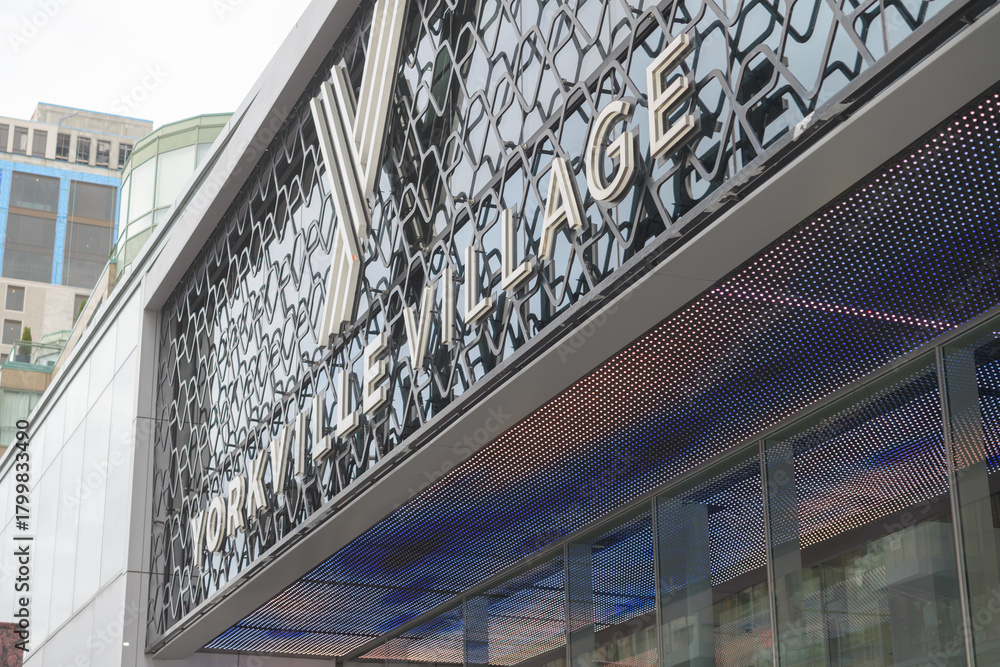 Fototapeta premium exterior building entrance facade and sign of Yorkville Village, a shopping mall, located at 55 Avenue Rd, Toronto